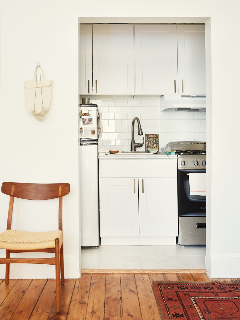 tiny white apartment kitchen