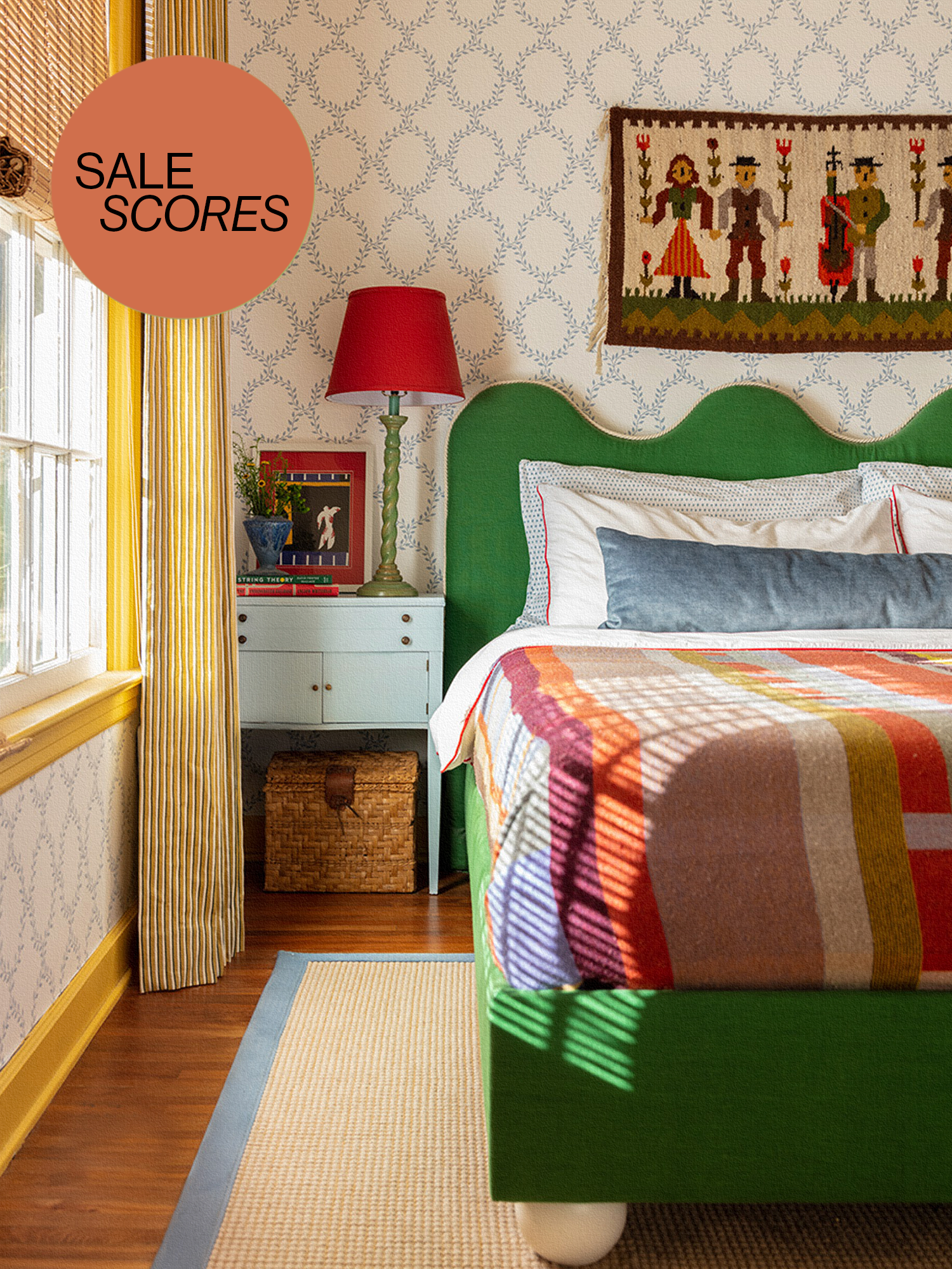 Colorful bedroom with green scalloped headboard and patterned quilt.